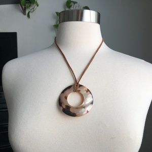 Circle Shell Pendant on a Brown Rope